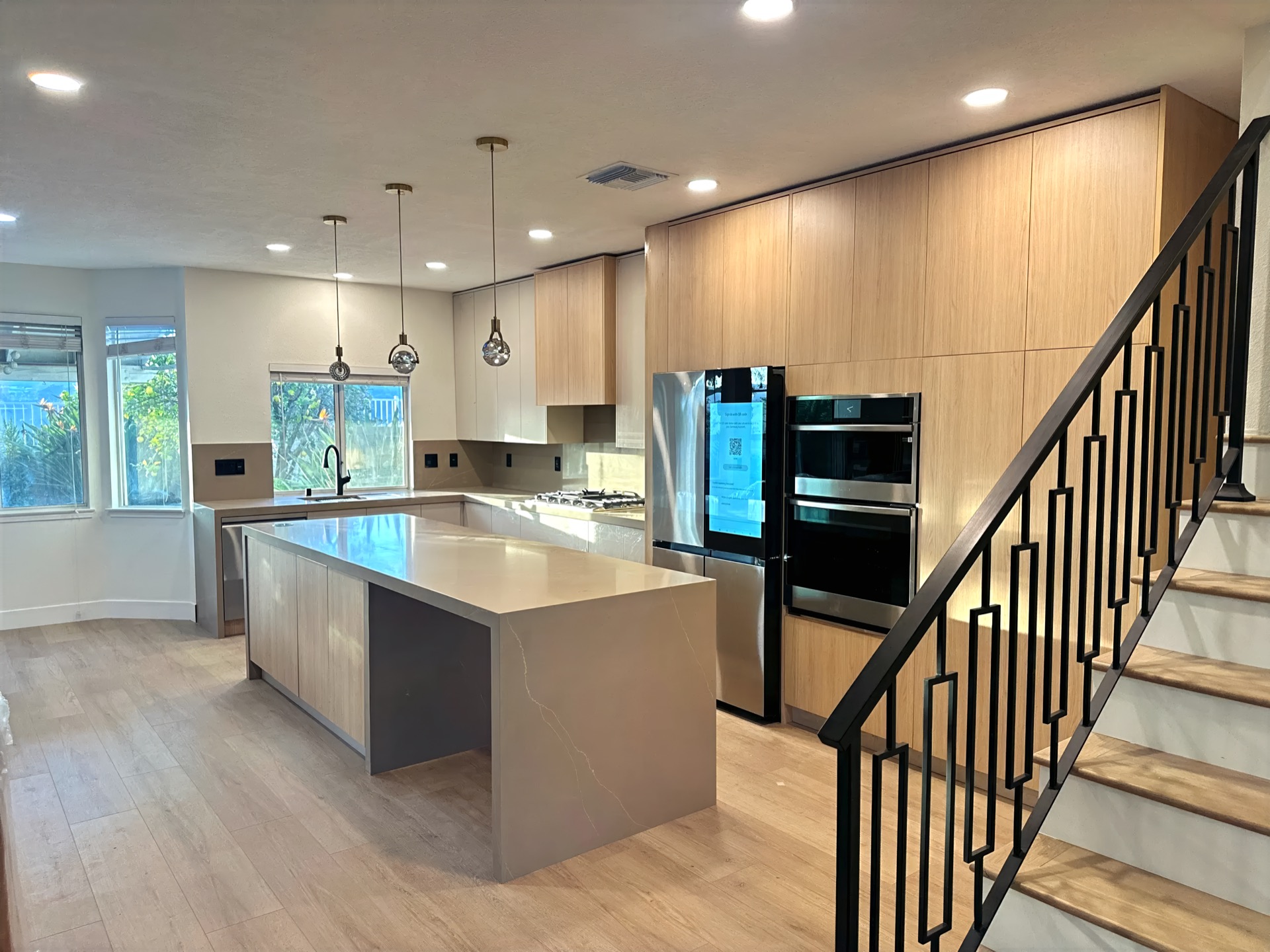 Luxury kitchen interior with marble island and warm wood cabinetry