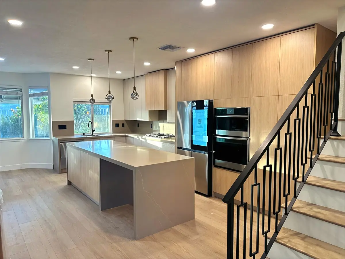 Luxury kitchen interior with marble island and warm wood cabinetry